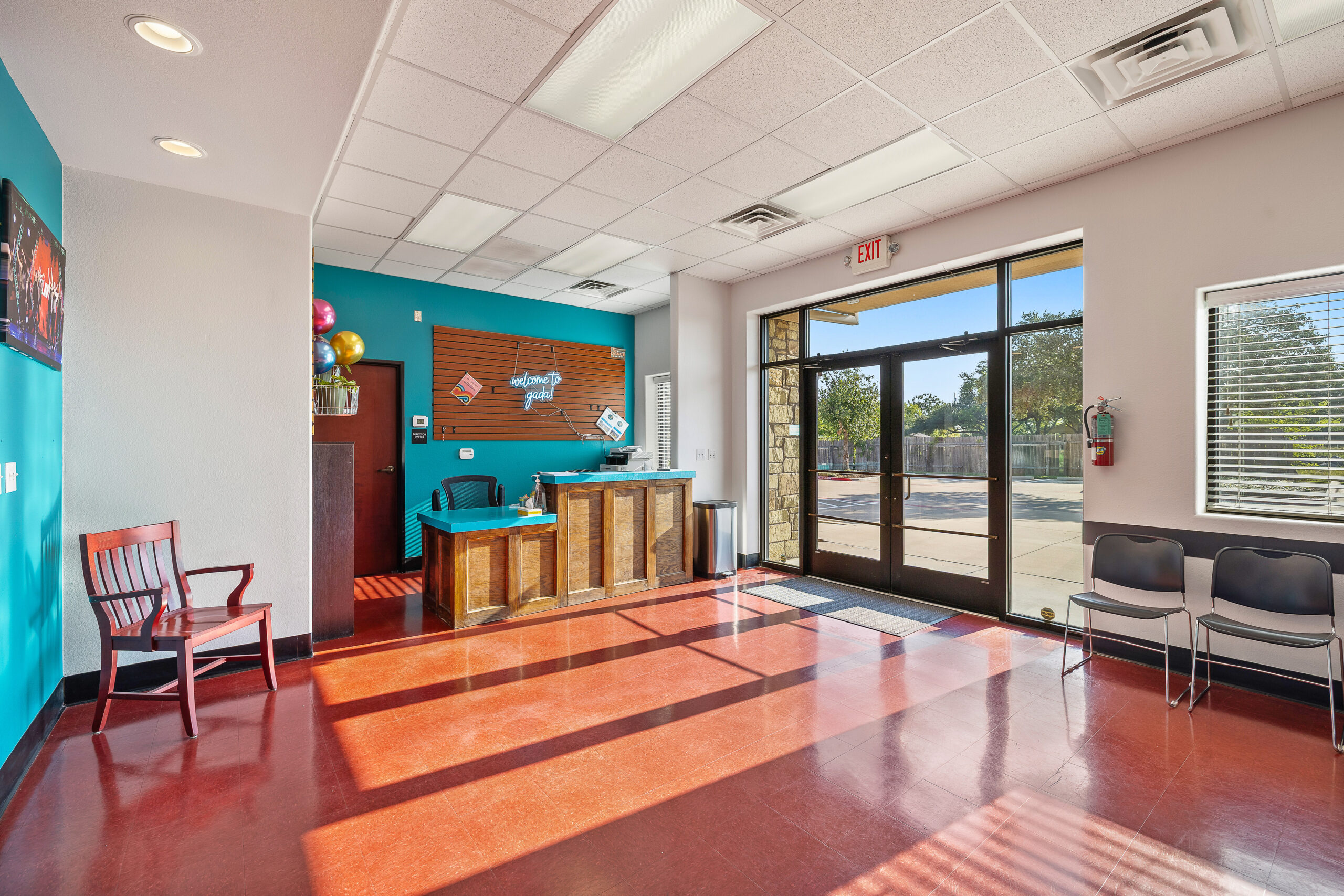 Spacious lobby with comfortable seating area, check-in desk, and family-friendly atmosphere