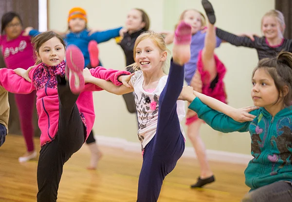 Kids doing high kick line